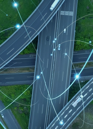 Cars and trucks driving on a highway interchange while transmitting data. 