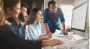 Partial image of a man and woman in an office happily reviewing their tech insurance.