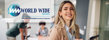 Smiling business woman uses a tablet while working on her insurance for staffing firms policy in the office. 